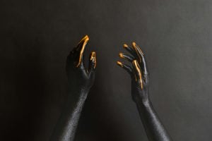 عکس دست زن با رنگ مشکی و نارنجی - عکس پس زمینه هنری از رنگ کردن دست